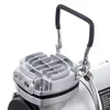 A close-up view of the top part of an airbrush compressor, focusing on the handle and the cooling fins of the motor housing. Podgląd zdjęcia produktu