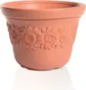 A terracotta-colored flower pot with a sunflower relief pattern. Náhľad obrázku produktu
