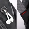 Close-up of a backpack, showing an earphone jack and a strap. Produktbild-Vorschau