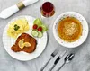 A table setting with a meal and a drink. Podgląd zdjęcia produktu