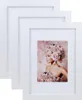 A stack of three white picture frames, with one frame displaying a portrait of a woman adorned with flowers. Produktbild-Vorschau