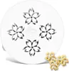 A white pasta maker attachment with a cherry blossom pattern, with two finished pasta shapes in the foreground. Náhľad obrázku produktu