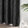 A black curtain with a silver wavy pattern is shown hanging next to a white wall and a green plant. Produktbild-Vorschau