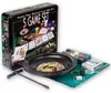 A casino game set including a roulette wheel, poker chips, cards, and dice, displayed on a green felt mat. Produktbild-Vorschau