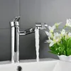 A chrome faucet with water running into a white sink, with a bouquet of white flowers in the background. Podgląd zdjęcia produktu