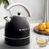 A black SWEISS vintage kettle is shown on a table with lemons and a cup of tea. Produktbild-Vorschau