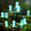 A group of glowing blue forest spirits are scattered around mossy ground and large mushrooms in a dark forest setting. Produktbild-Vorschau