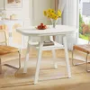 A white dining table with a vase of yellow flowers and a bowl of apples on it, set in a well-lit room with chairs and a cabinet in the background. Produktbild-Vorschau