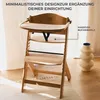 A wooden high chair is shown in a well-lit room with sheer curtains in the background. Voir les images du produit