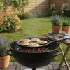 Pancakes are being cooked on a cast iron griddle on a grill in a backyard setting. Produktbild-Vorschau