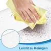 A hand is cleaning a surface with a yellow microfiber cloth, showing dust being removed. A magnified inset shows a clean, sparkling surface. Náhled obrázku produktu