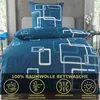 A bed with blue and white patterned bedding, including a duvet cover and pillowcase. Produktbild-Vorschau