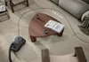 A vacuum cleaner is shown in a living room setting, with a dotted line indicating its cleaning path around a coffee table. Produktbild-Vorschau