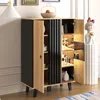 A modern cabinet with open doors, displaying shelves with various items and decorative elements. Produktbild-Vorschau
