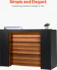 A reception desk with wooden shelves and a computer monitor on top. Anteprima dell’immagine prodotto