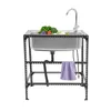 A stainless steel sink with a faucet and some vegetables on a black metal stand, with a purple towel hanging from the stand. Podgląd zdjęcia produktu
