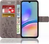 A grey flip case for a smartphone, with cards and euro banknotes inserted into the card slots. The case has a floral embossed pattern. Produktbild-Vorschau