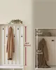 A collage showing two views of a white slatted entryway organizer with hooks and shelves, featuring dimensions overlaid on the image. Náhled obrázku produktu