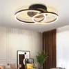A modern ceiling light fixture with two interlocking rings, illuminated and mounted on a white ceiling. Anteprima dell’immagine prodotto