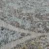 A close-up view of a textured rug with a vintage floral pattern. Produktbild-Vorschau