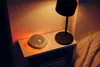 A bedside table with a sound machine and a lamp. Náhľad obrázku produktu