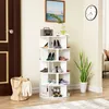 A white rotating shoe rack filled with various shoes, placed in a room next to a door and a plant. A painting hangs on the wall above the shoe rack. Podgląd zdjęcia produktu
