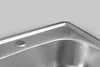 Close-up view of a stainless steel sink corner with a circular indentation. Náhled obrázku produktu