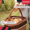 A person is holding a woven basket filled with mushrooms. Produktbild-Vorschau