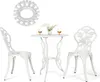 A white metal bistro set with two chairs and a table, decorated with rose patterns. The table has two glasses of amber liquid and a small vase of white flowers. Náhľad obrázku produktu