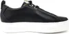 A side view of a black leather sneaker with a white platform sole. Voir les images du produit