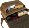 A close-up view of the interior of a brown leather bag, showing various items packed inside. Podgląd zdjęcia produktu