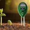 A soil meter is placed in the ground next to a sprouting seedling and a young plant. Podgląd zdjęcia produktu