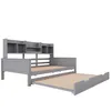 A gray wooden daybed with a pull-out trundle bed and a shelf unit above. Podgląd zdjęcia produktu