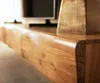 A close-up shot of a wooden lowboard with a curved edge, showing the wood grain and texture. Produktbild-Vorschau