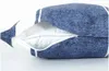 A close-up view of a blue pillow with a zipper partially open, revealing the white inner lining. Náhled obrázku produktu