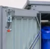 Close-up of a metal storage box latch and a blue barrel inside. Náhled obrázku produktu