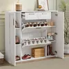 A white shoe cabinet with multiple storage compartments and drawers, filled with shoes and some decorative items.