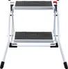 A white, two-step folding ladder with black anti-slip treads. Voir les images du produit