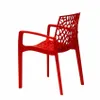 A red plastic chair with an intricate, web-like design on the back and seat. Produktbild-Vorschau