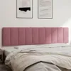A pink upholstered headboard is mounted on a wall above a bed with white and beige bedding. Produktbild-Vorschau