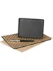 A black leather BOSS wallet is placed on top of a notebook with a polka dot pattern, with a pen lying across the notebook. Podgląd zdjęcia produktu