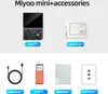 A collage of images showing a handheld game console and its accessories, with labels indicating each item. Produktbild-Vorschau