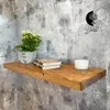 A wooden shelf mounted on a textured gray wall, decorated with a potted plant, two books, and a candle. Produktbild-Vorschau