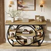 A console table with a circular base, decorated with various items, in a room setting. Anteprima dell’immagine prodotto