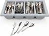 A cutlery organizer tray filled with silverware, with additional silverware laid out in front of it. Produktbild-Vorschau