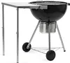 A black kettle grill with a silver side table attached. Náhled obrázku produktu
