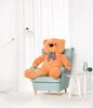 A large teddy bear sits in a chair in a well-lit room with white curtains. Podgląd zdjęcia produktu