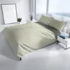 A bed with bedding in a modern room with a large window. Produktbild-Vorschau