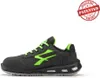 A side view of a black and green safety shoe against a white background. Voir les images du produit