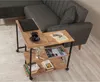 A side table with a laptop, cup, book, and magazines next to a couch. Voir les images du produit